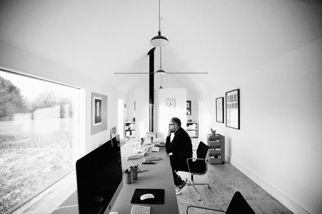 graphic artist anthony burrill at his desk
