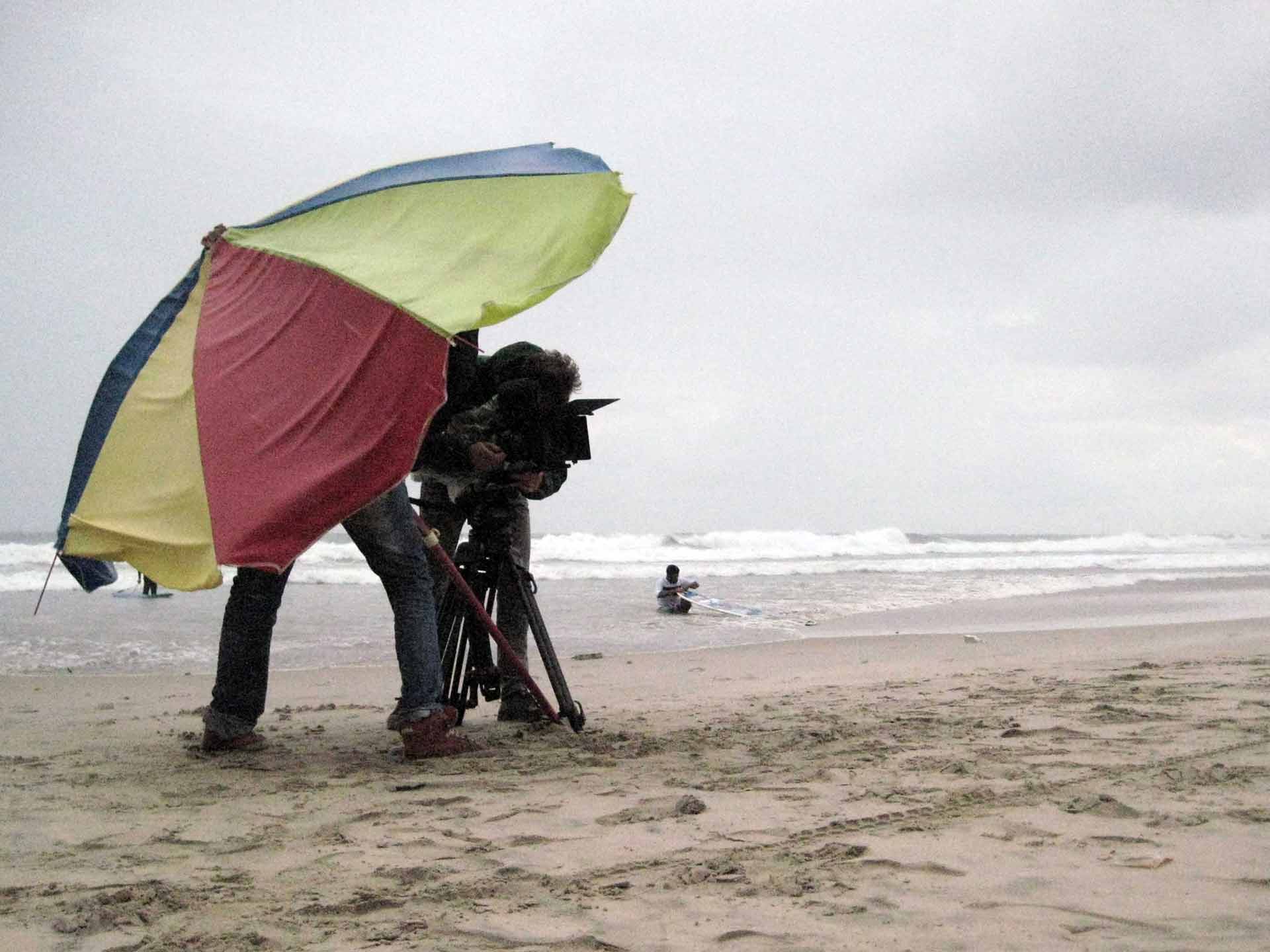 gaza-surf-club-shooting-on-beach-camera-under-umbrella